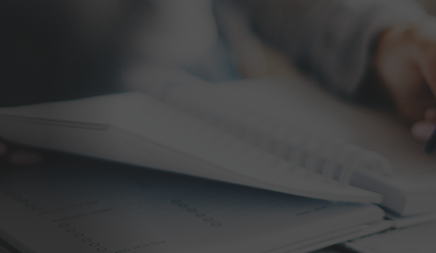 Close-up shot of a person writing in a workbook.