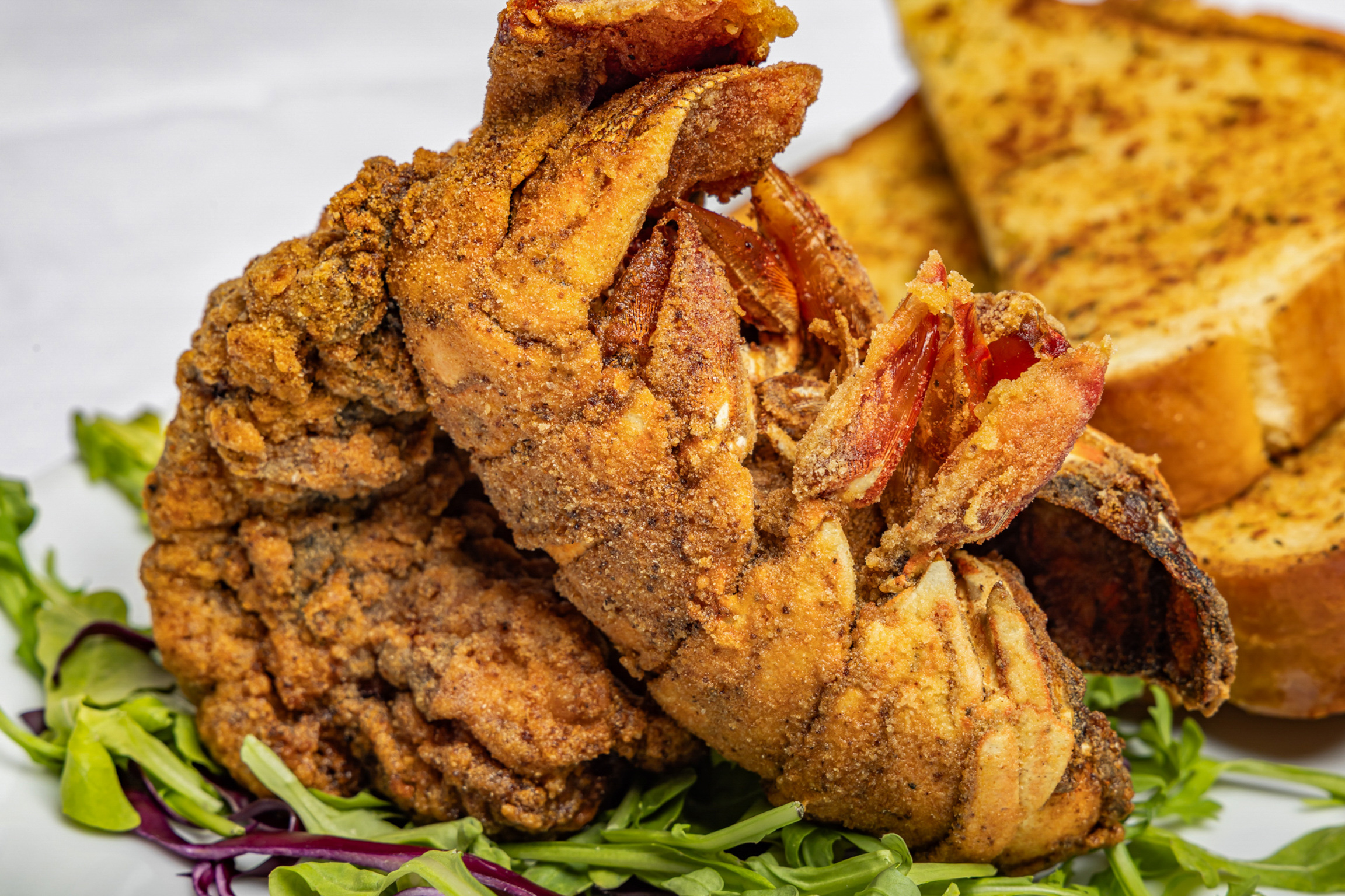 Golden-fried lobster tail, crispy on the outside and buttery tender inside, served with a light house seasoning.