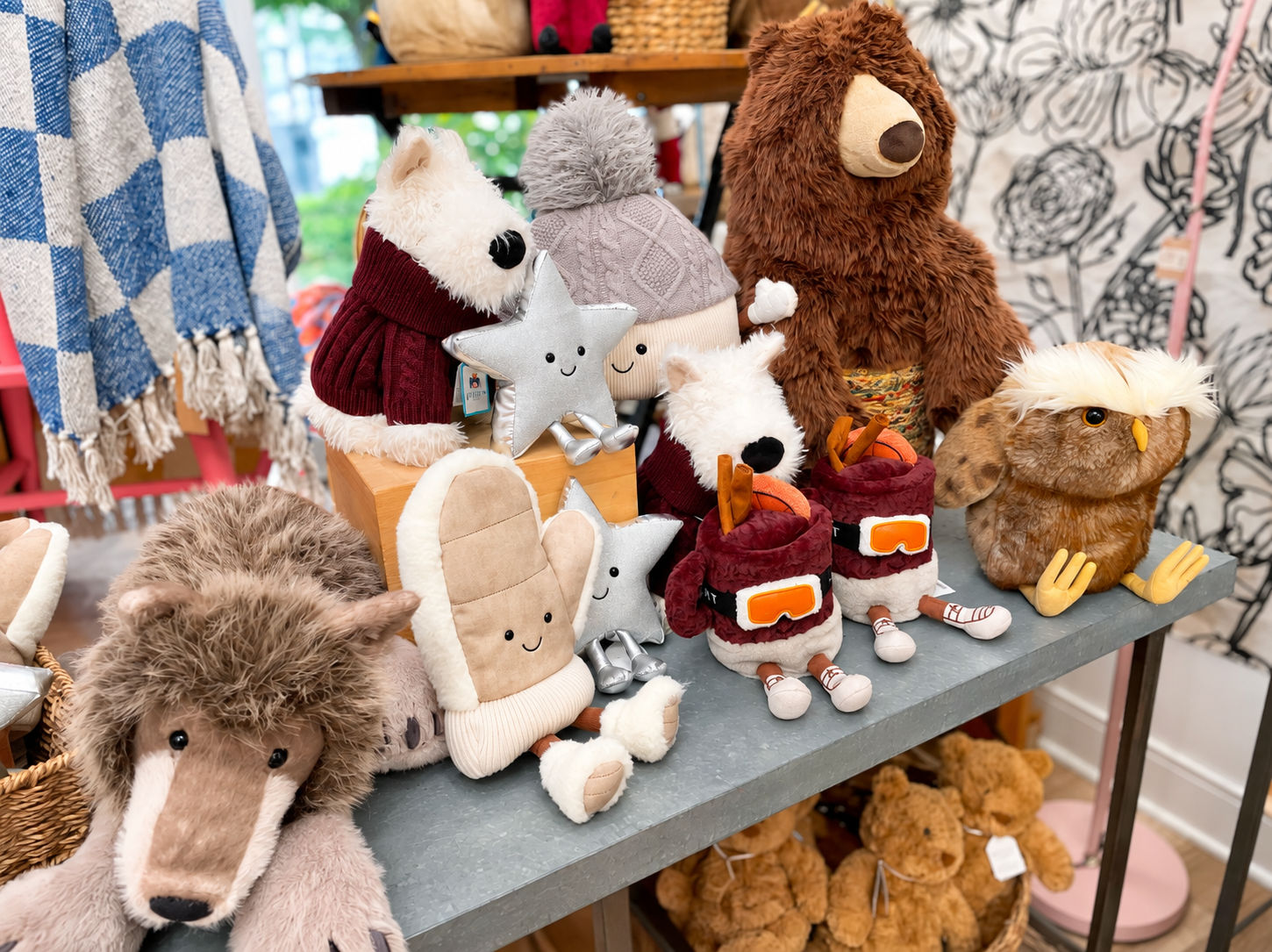 A cheerful collection of plush woodland animals, smiling stars, winter hats, and playful ski-themed  