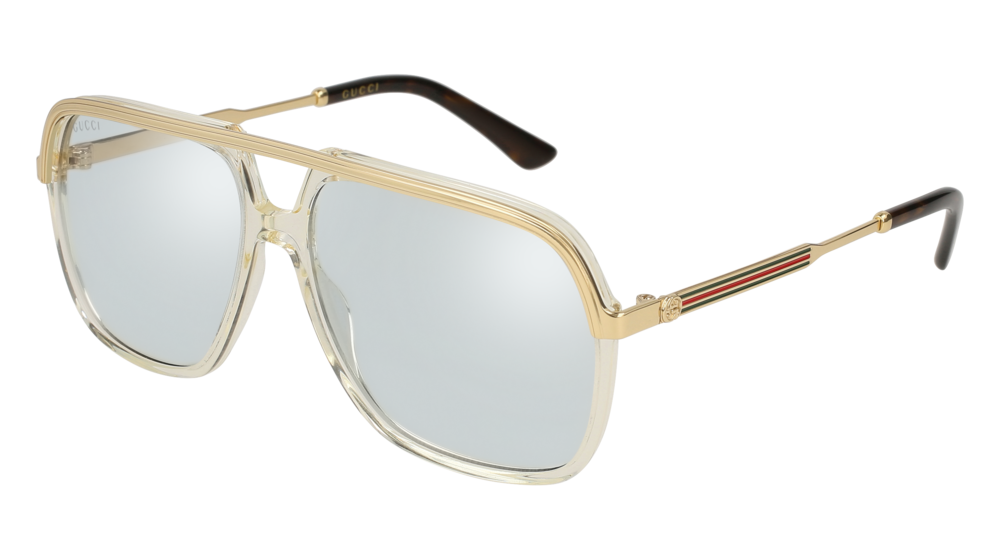 A pair of Gucci aviator sunglasses with gold-tone metal frames and clear acetate details. The lenses are silver mirrored, and the temples feature the iconic Gucci red and green stripe.
