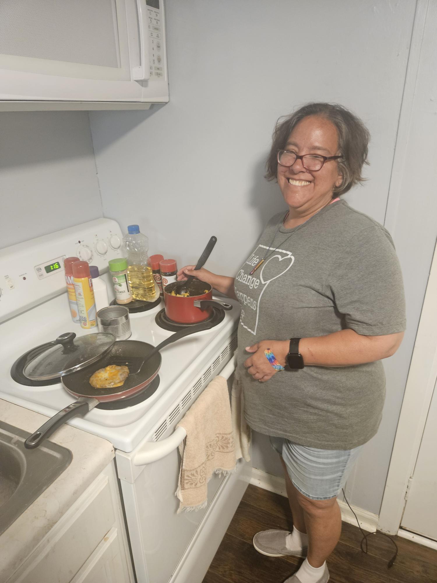 Caregiver assisting an older adult with daily care and support at home.