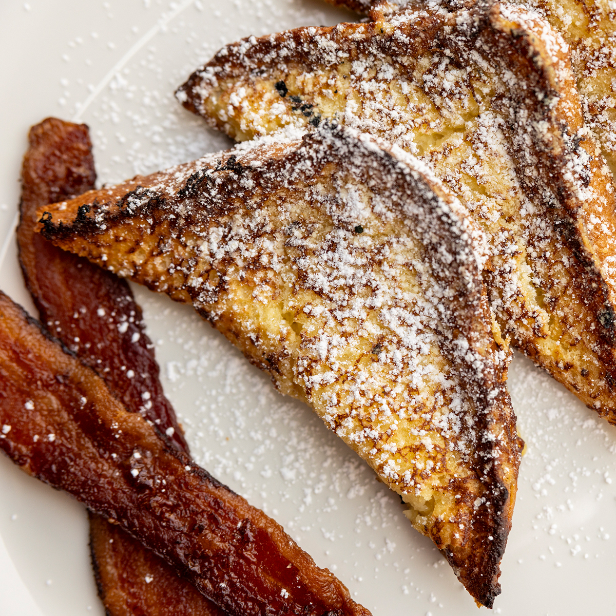 French Toast | challah bread, bacon or sausage, fresh fruit, maple syrup
