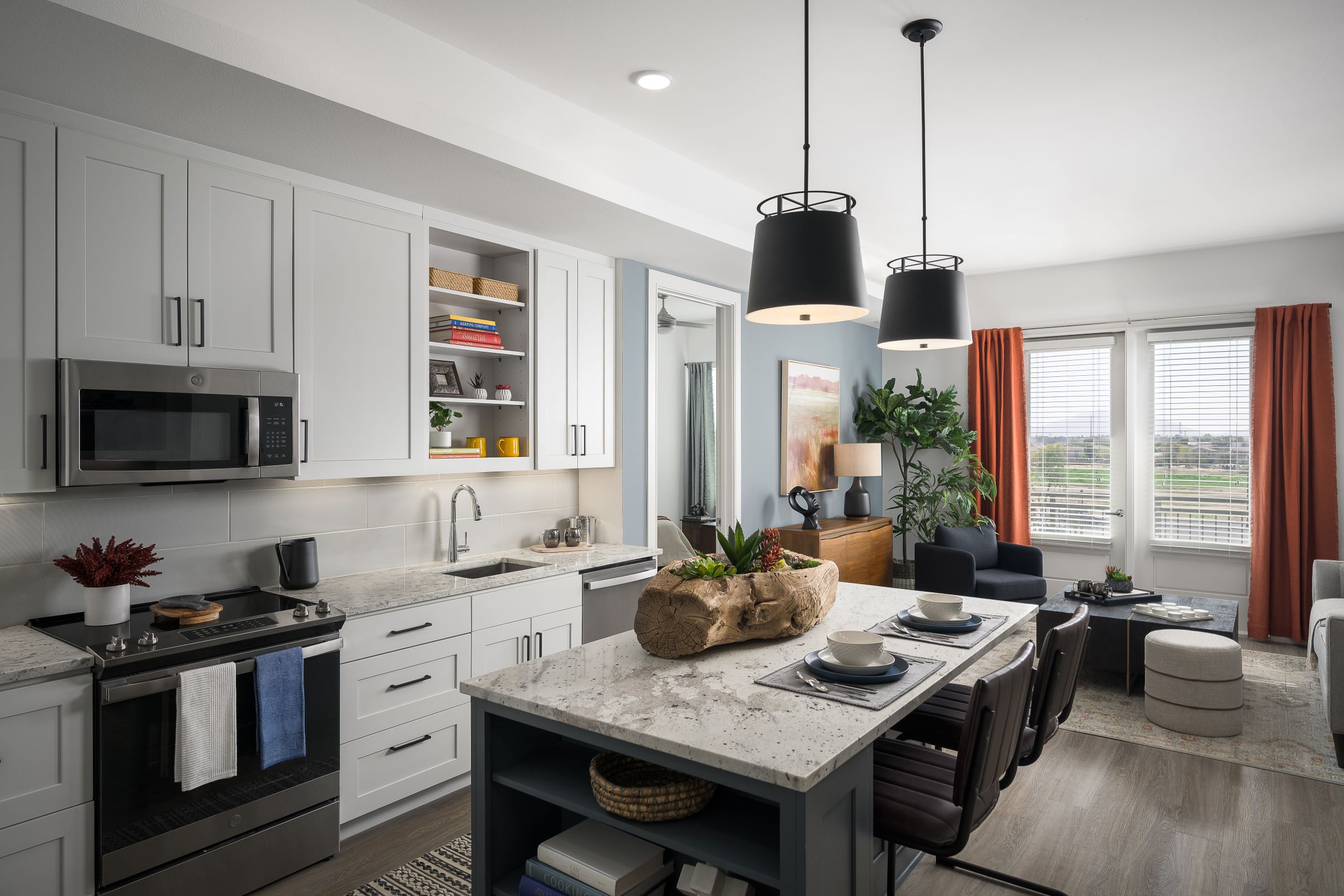 Kitchen with island and modern matte black pendant lights at Camden Gilbert apartments in Gilbert, AZ