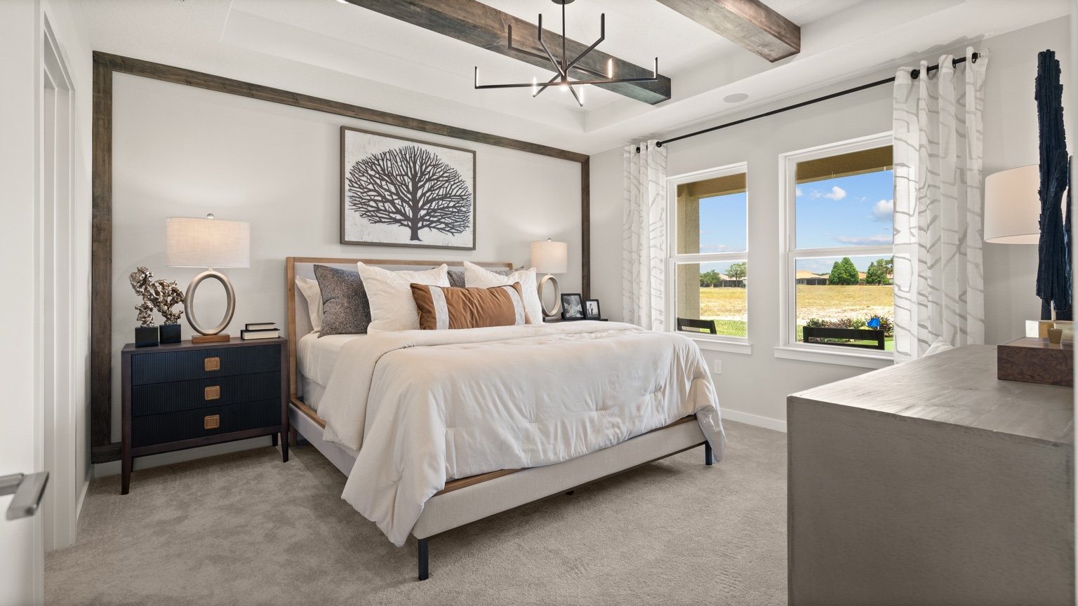 The Jupiter Model Home Primary Suite at Grasslands West by DRB Homes