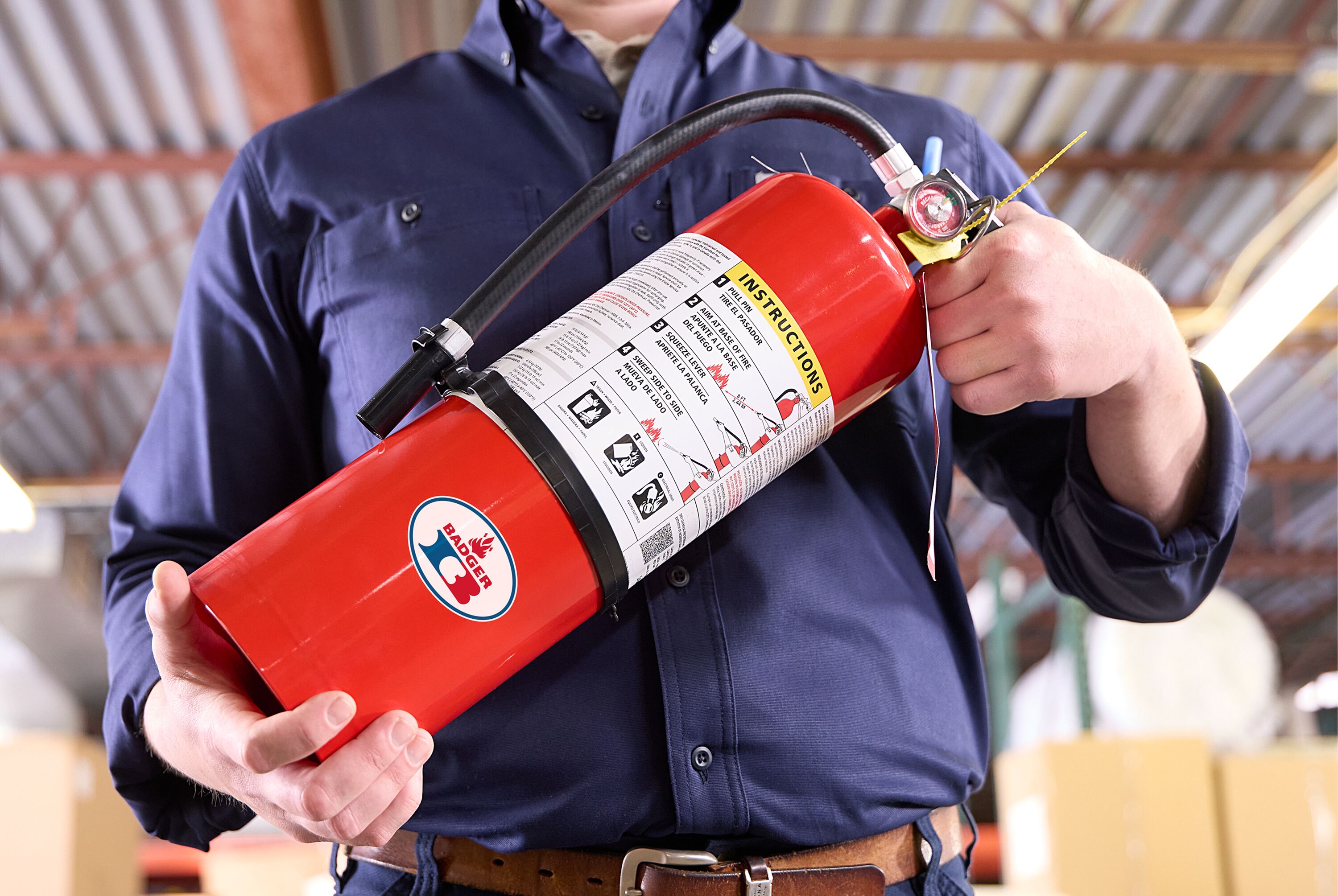 A man carries a Badger Fire Extinguisher