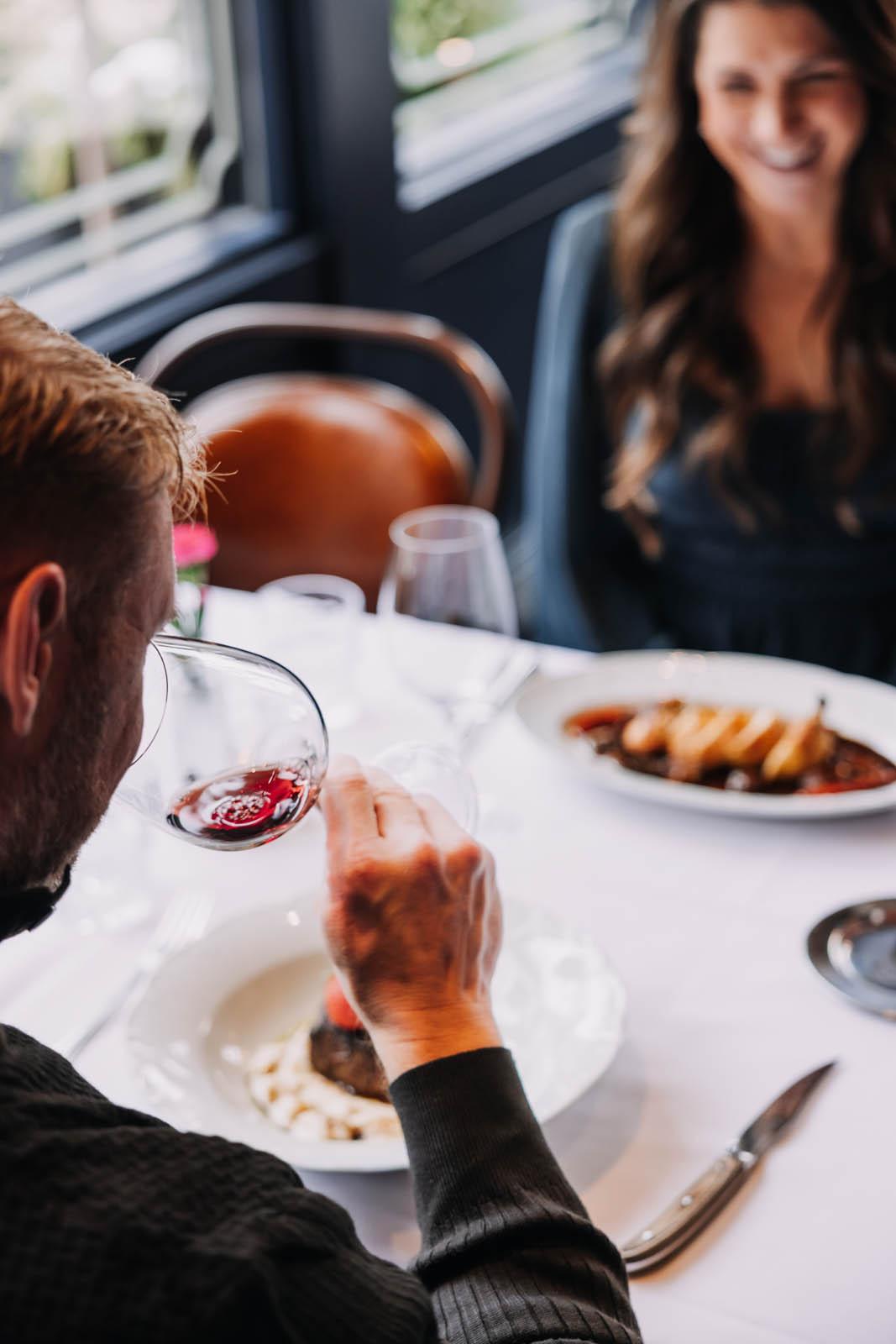 Guest sniffing wine before tasting