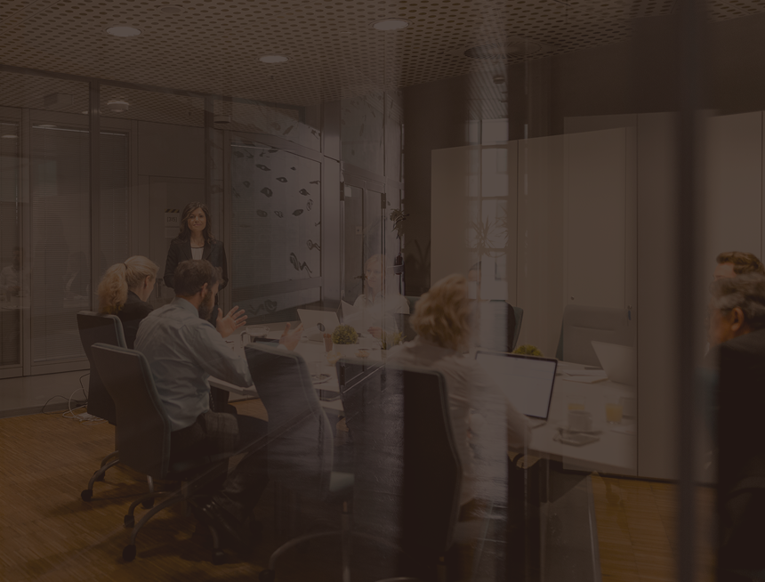 Wealth management team collaborating in a boardroom.