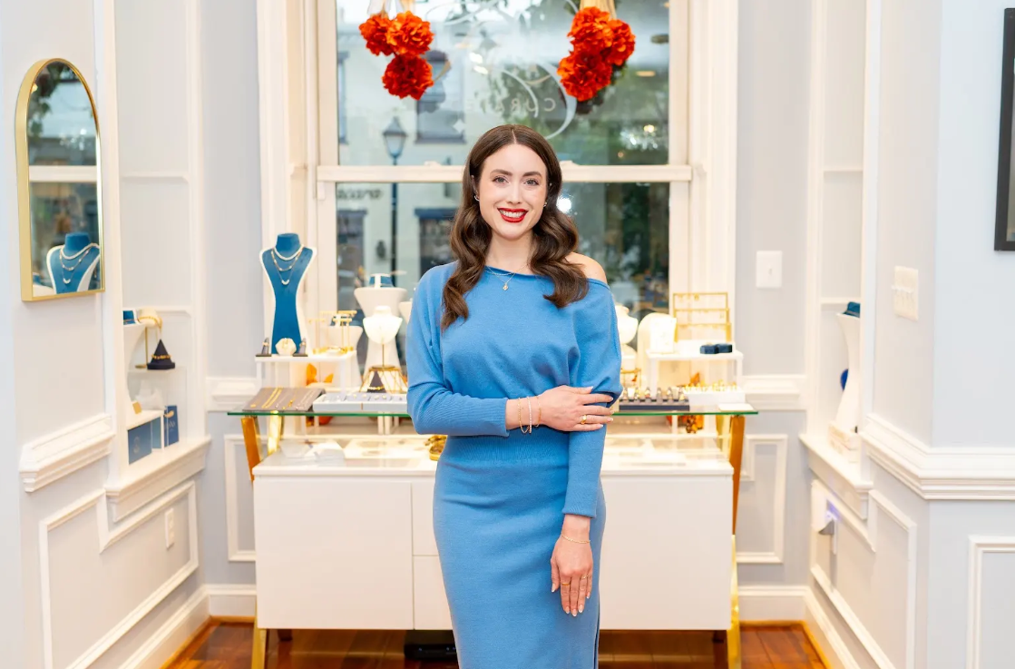Blue knit dress pairs with delicate necklaces, bracelets, and rings at Eliana Curated. Explore jewelry and boutique style in a bright, welcoming setting in Old Town Alexandria, Virginia. Get the look.