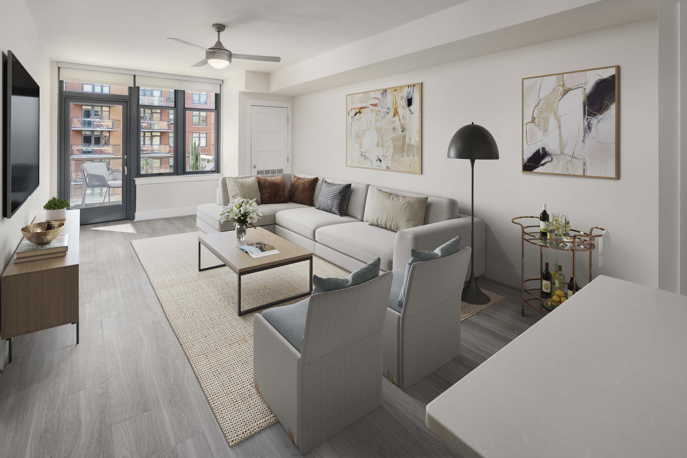 Contemporary style living room with a lighted ceiling fan and balcony at Camden NoMa Apartments in Washington, DC.