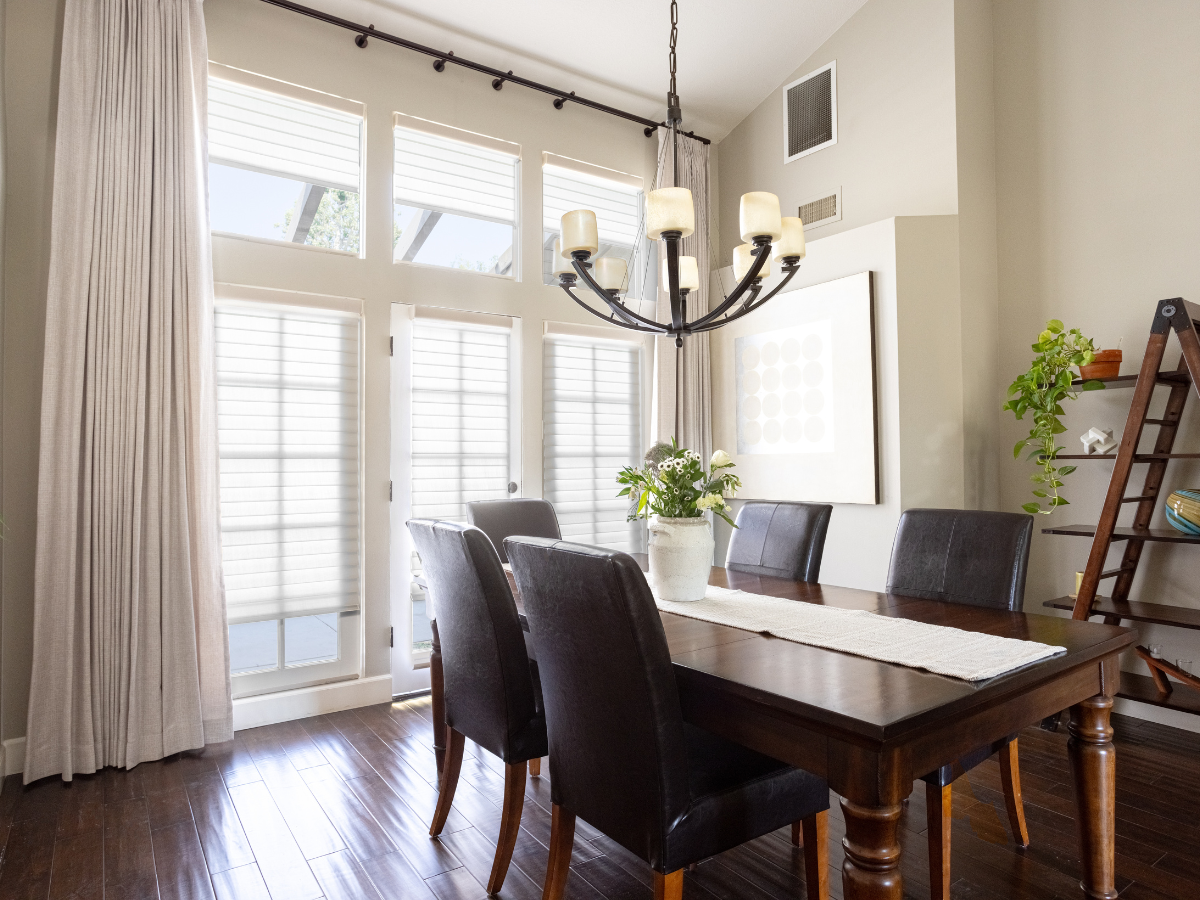 Motorized drapes & shades in a dark and moody dining room