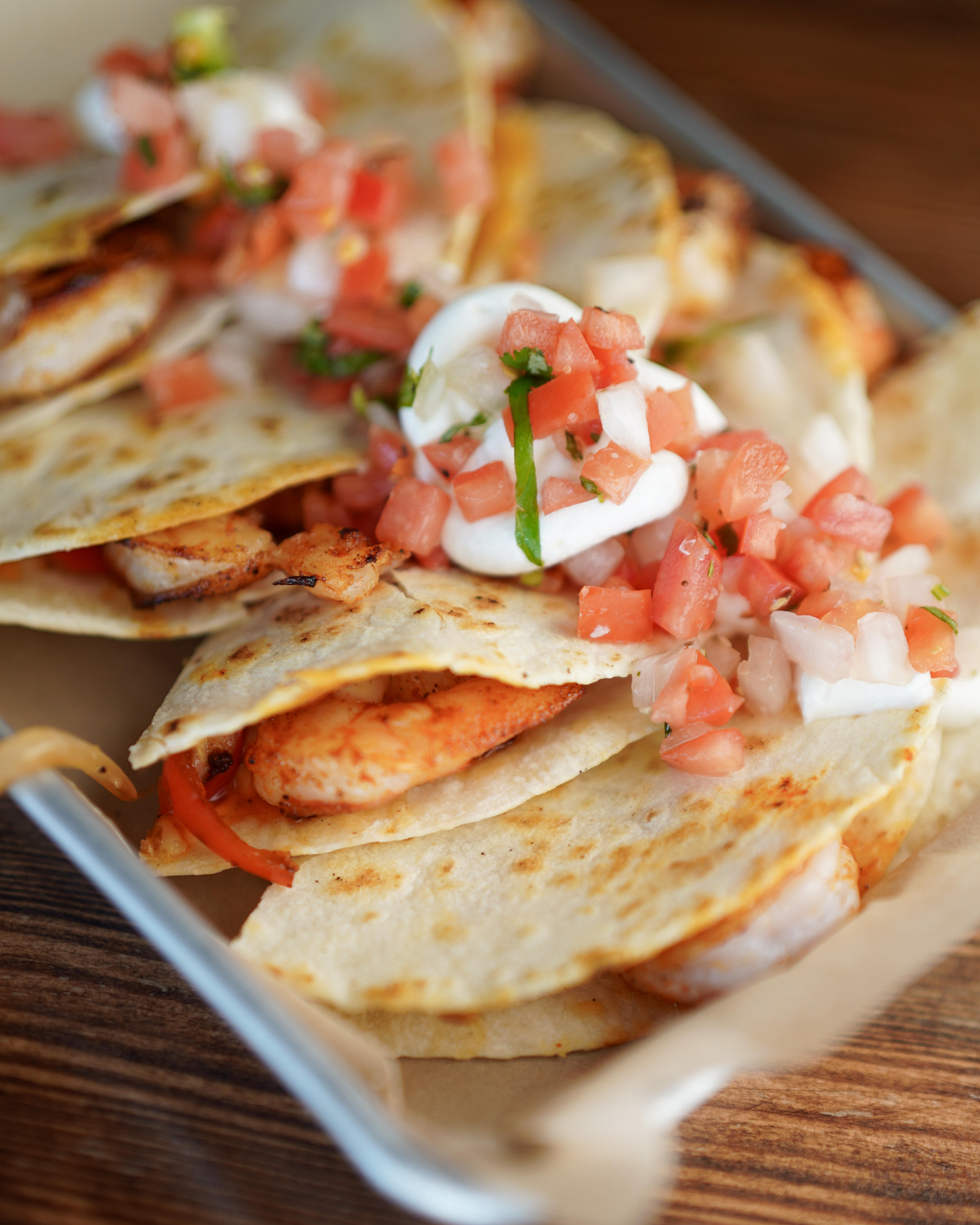 QUESADILLA - Your choice of sautéed shrimp or grilled chicken, with onions, bell peppers and nacho c Joey’s Seafood Restaurants Saskatoon (306)955-5858