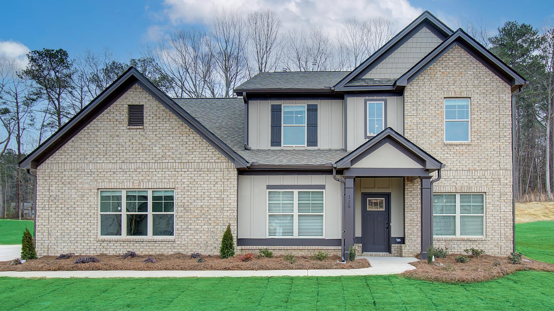 Two story home with tan brick in DRB Homes Luella Grove Community