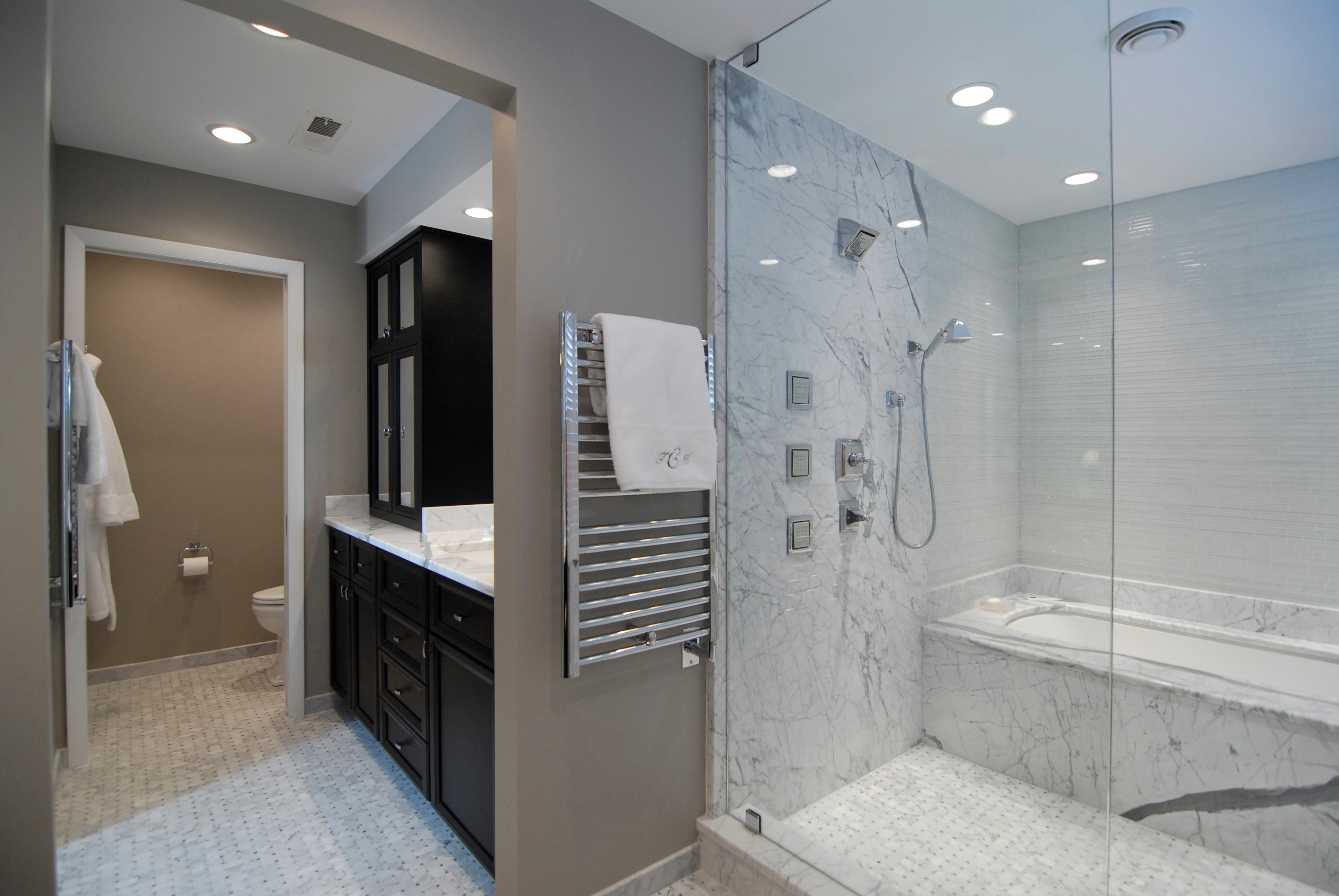 Espresso finish bathroom cabinets and walk in shower and tub combination.