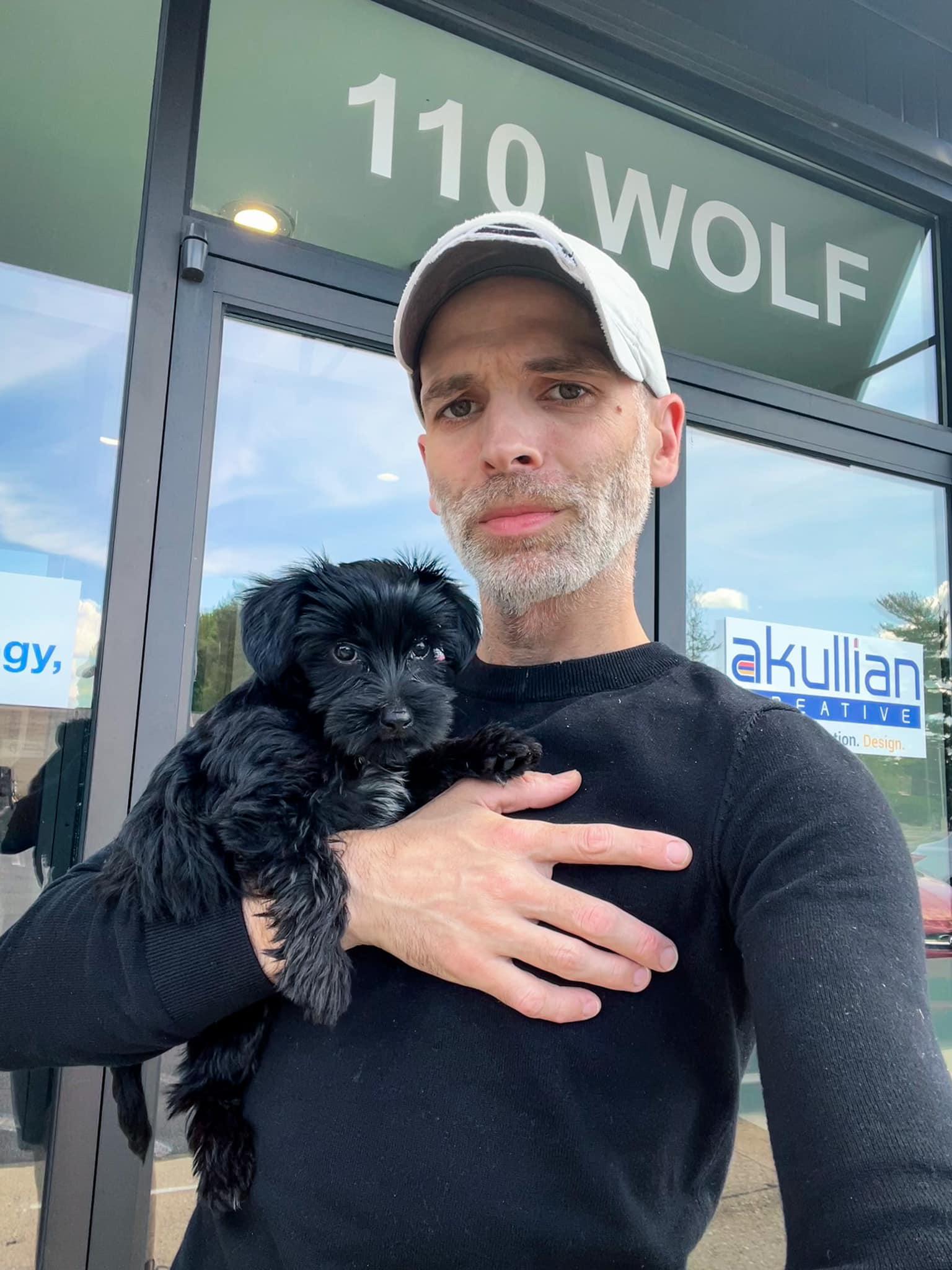 Rich Akullian and Studio A's main dog Molly pose outside of 110 Wolf Road in Albany, NY where Studio A (Akullian Creative's home studio) is located.