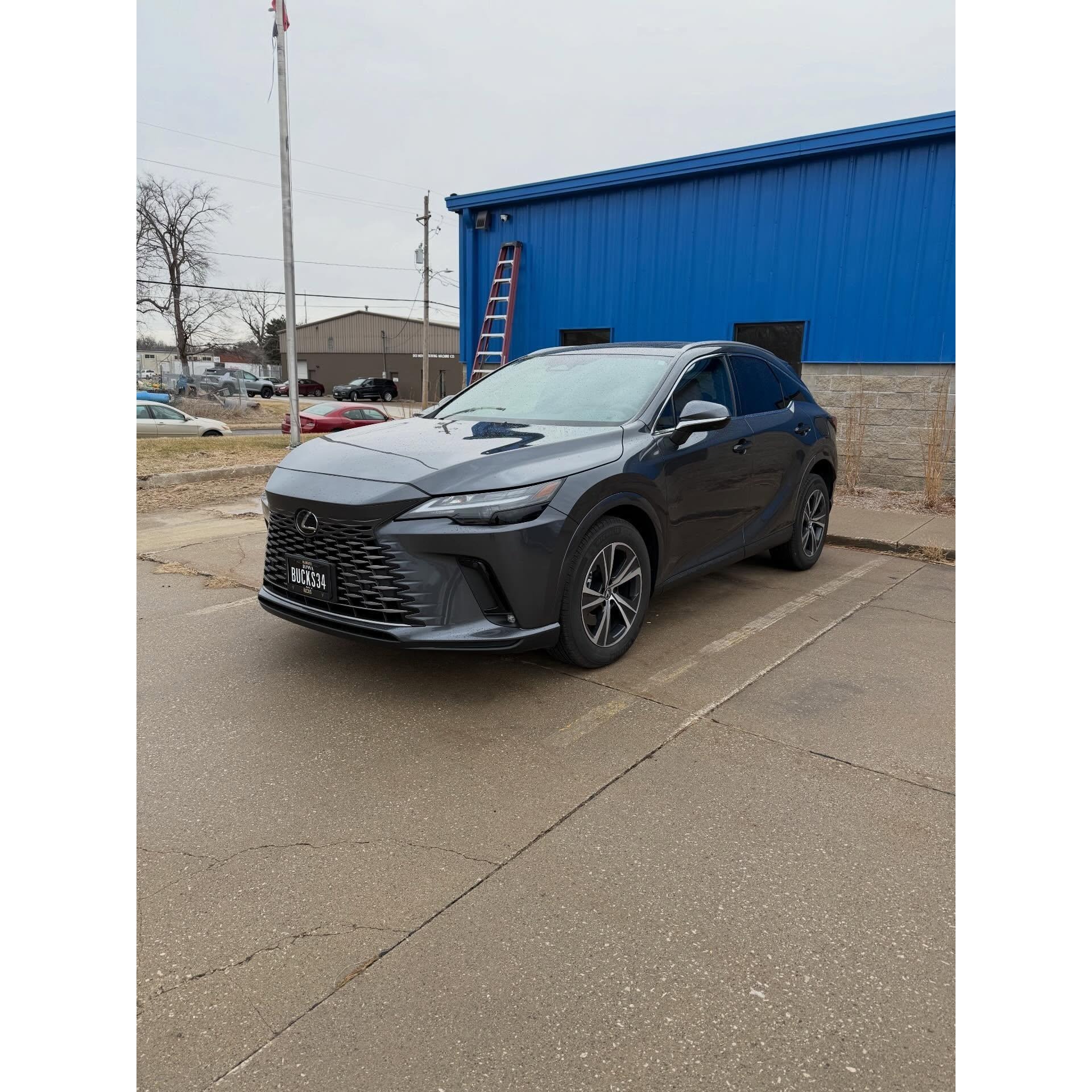 Gray luxury SUV parked outside after detailing, featuring a clean exterior, refreshed wheels, and professional vehicle presentation for AMT Mobile Detailing.