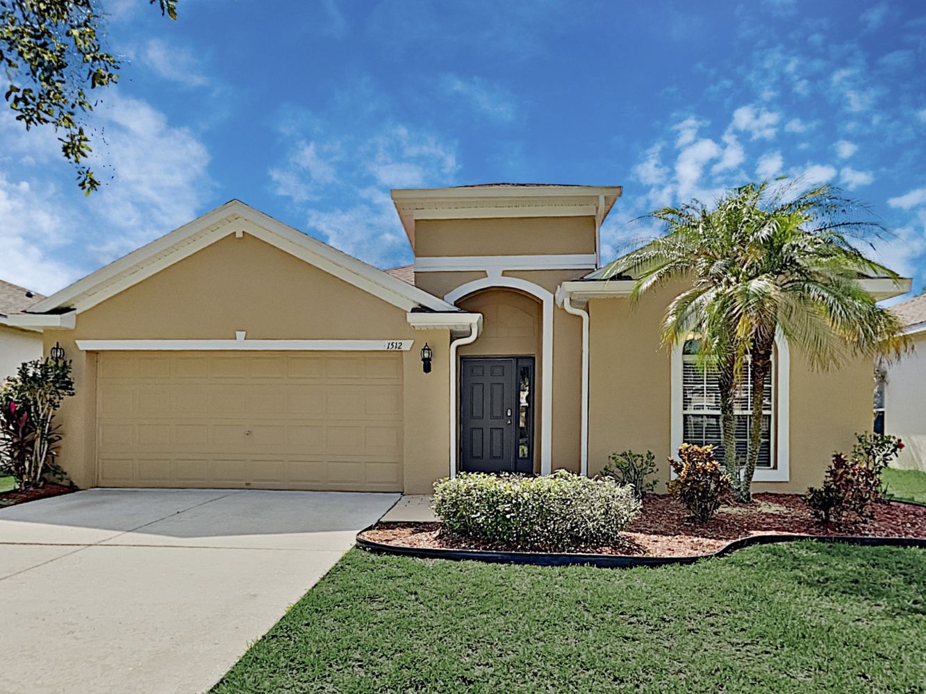 Front of house with two-car garage at Invitation Homes Tampa.