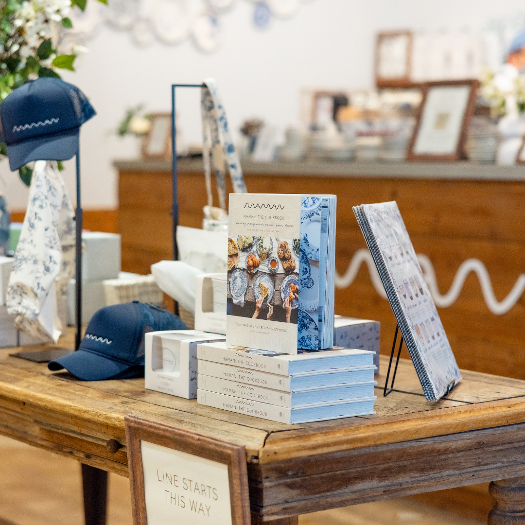 On the table, various items are neatly arranged, including several cookbooks. They are stacked with  