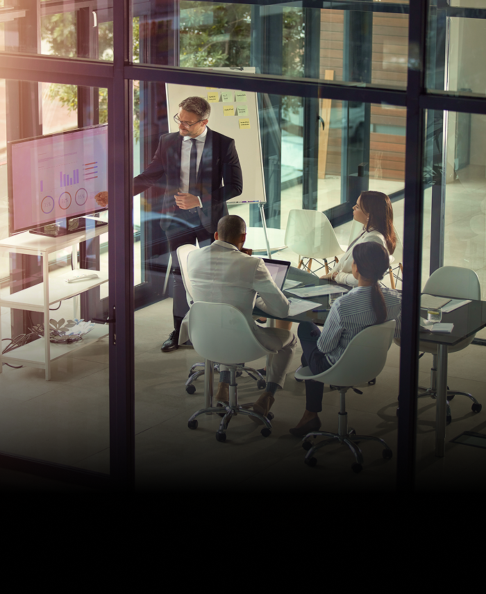 Wealth advisors meeting in a boardroom to go over projections and trends.