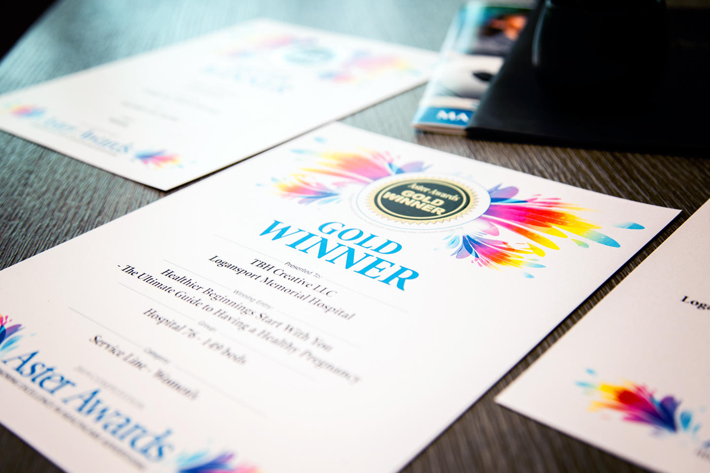 Certificates announcing TBH Creative’s three Aster Award wins for excellence in healthcare marketing