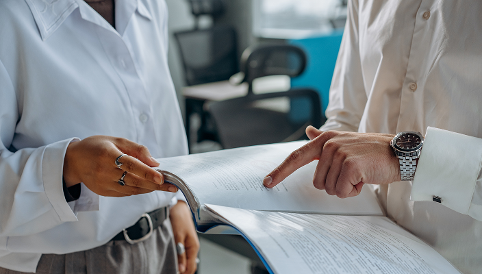 Close-up of a client and their advisor reviewing a printed report.