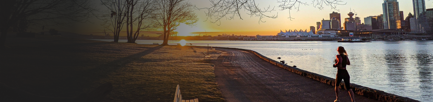 Woman running along the Vancouver waterfront trail.