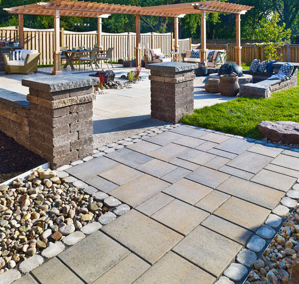 Complete backyard with polished paver stone decking and walkways