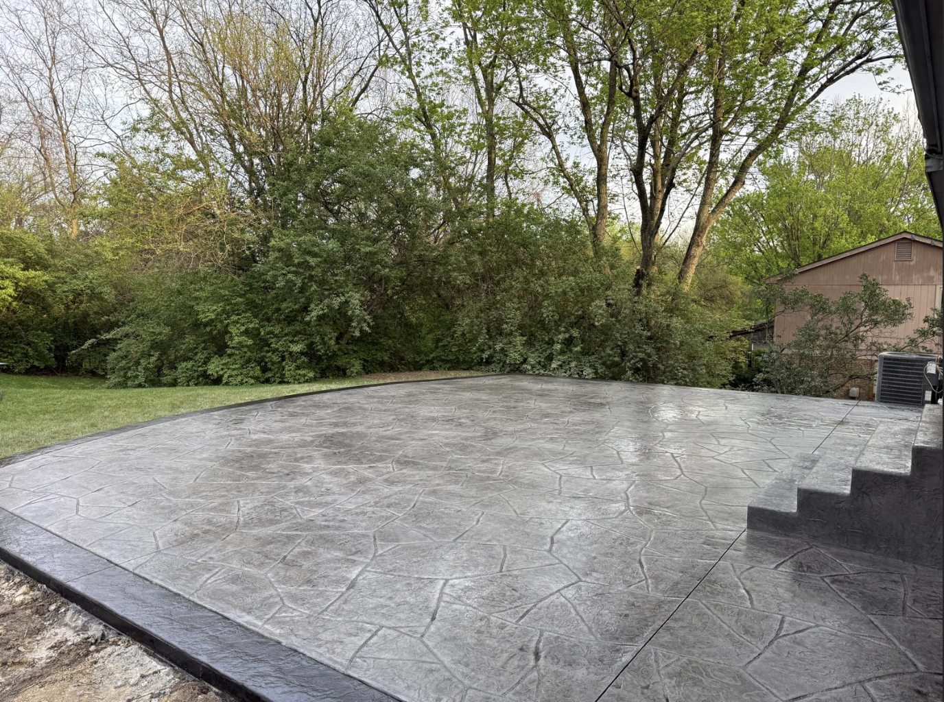 We love doing stamped concrete projects, like this concrete patio for a home in Montgomery, Ohio. After the pour, we used a stamp to create the pattern then stained the surface. We also created the darker border around the edge, which gives it a finished look. Are you thinking about a new patio for your backyard? Call us today for a free estimate.