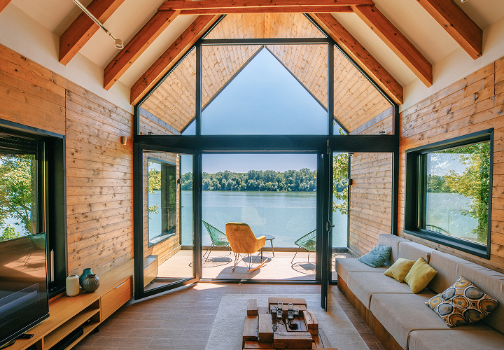The stunning interior of a cottage with a lakefront view.