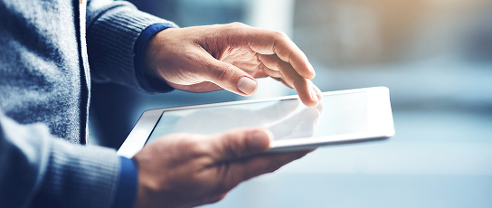 Close up of a person scrolling on their tablet.