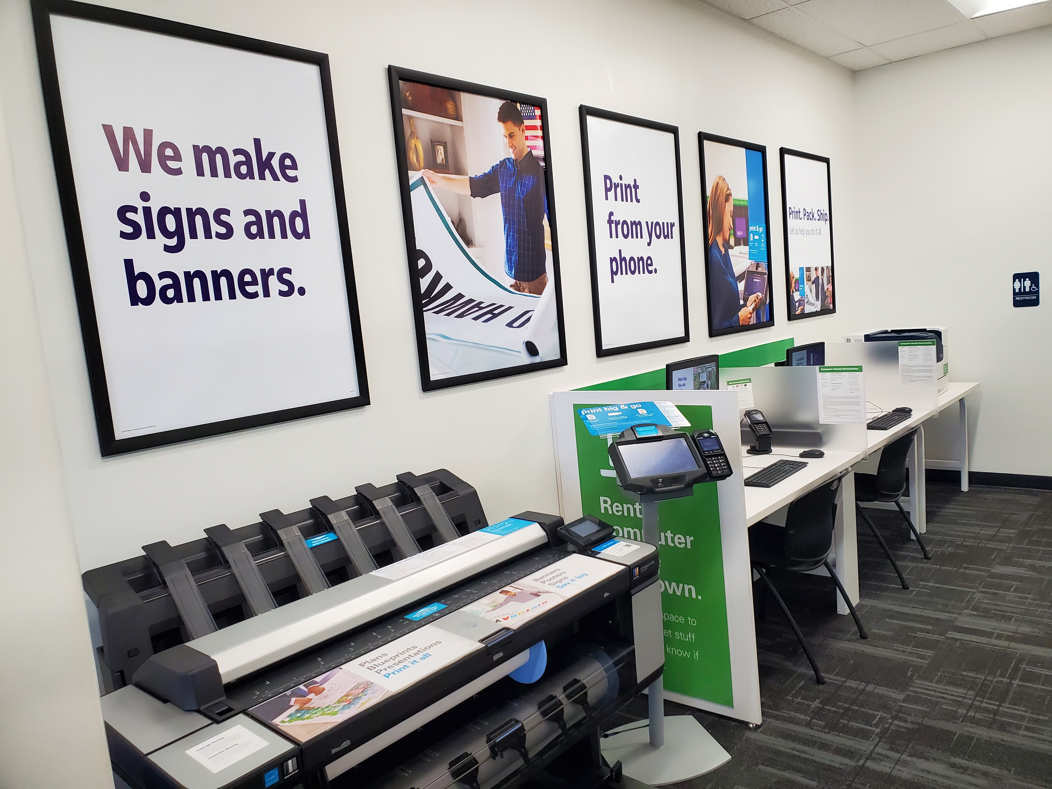 Large format printer and computer rental stations at FedEx Office in College Station Texas for signs, banners, and document printing.