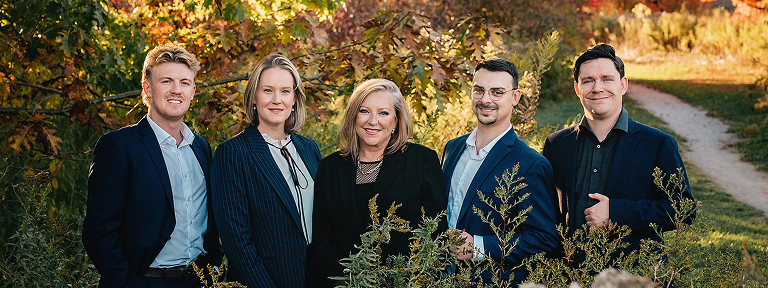 The Brenda Miller Family Wealth team posed outside among the multi-coloured autumn trees.