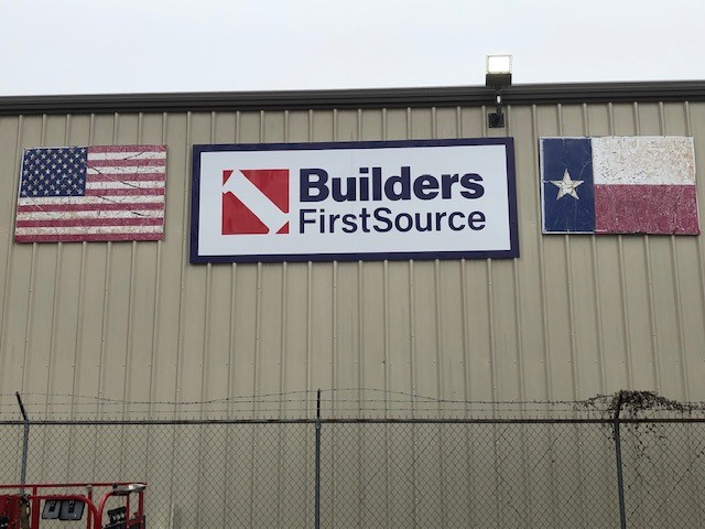 Builders FirstSource lumber yard building sign in Houston, TX.