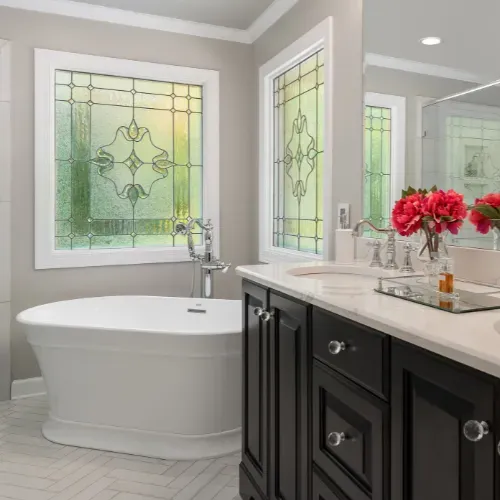 High-end bathroom remodel in Central North Carolina featuring a freestanding soaking tub, custom vanity, and large windows with natural light. This luxury bathroom renovation reflects precision craftsmanship by a professional remodeling contractor.