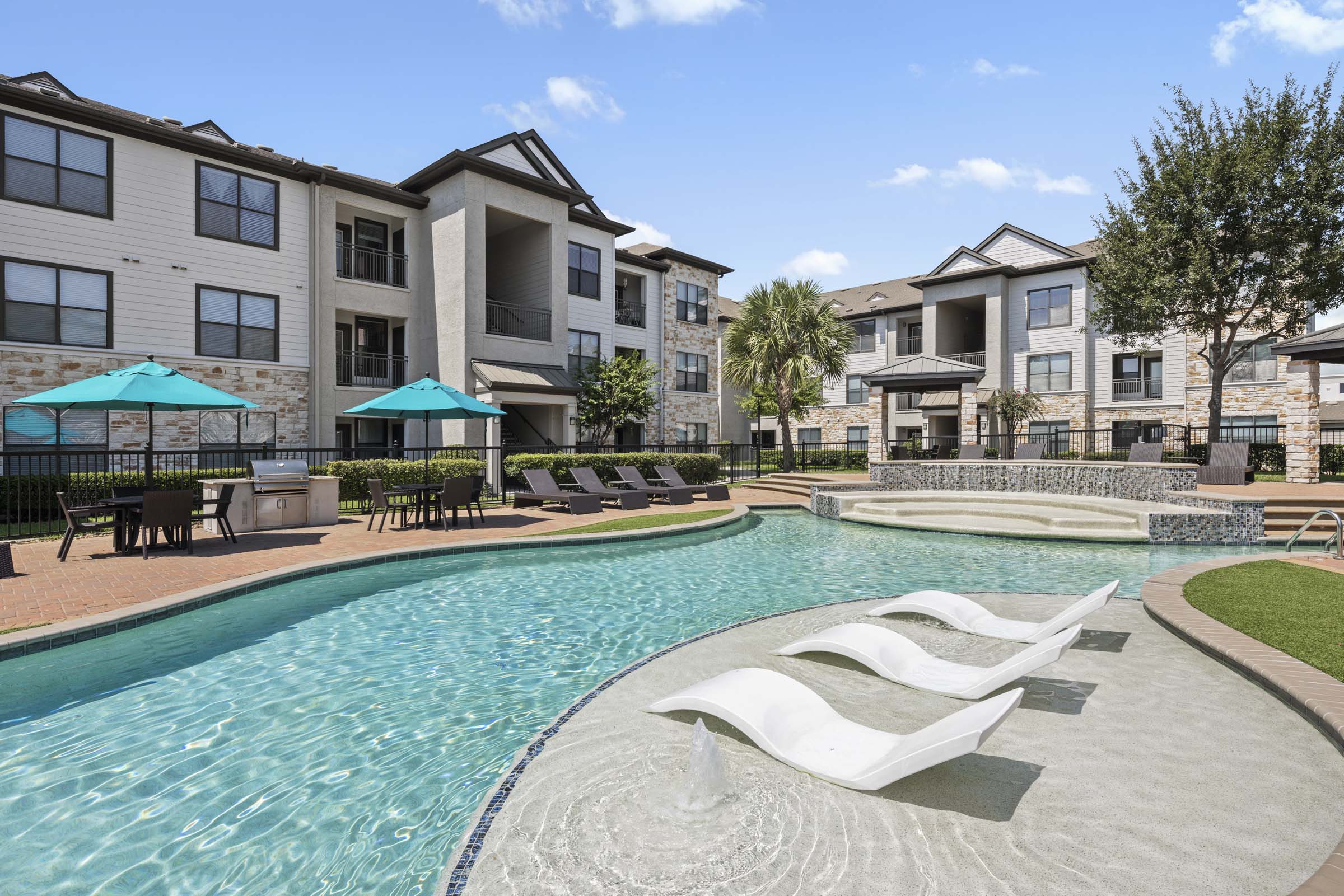 Tanning Deck and Water Feature at the Resort-Style Pool