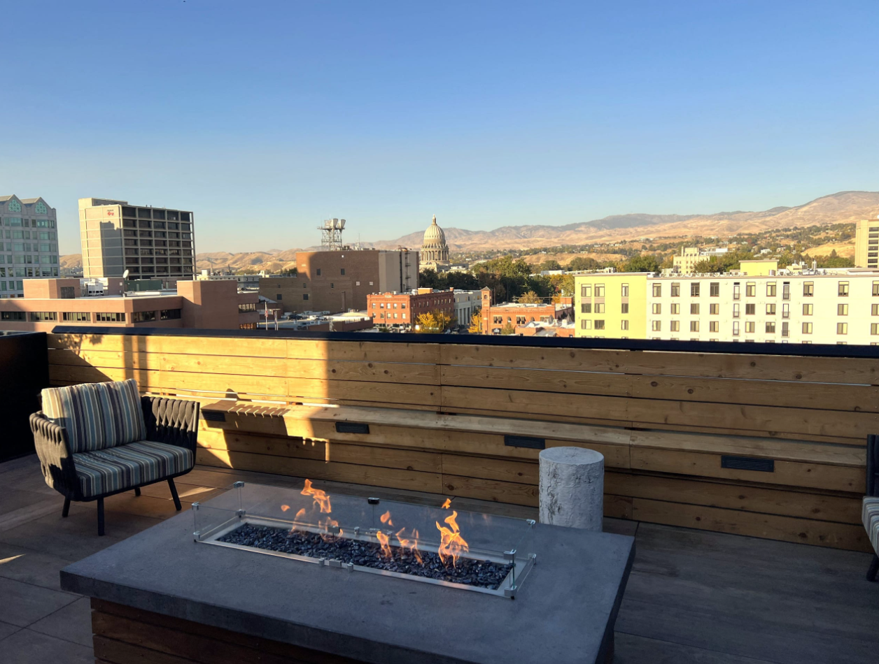 Rooftop patio lounge with a fire pit overlooking downtown Boise