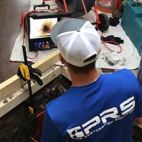 Pipe Restoration Solutions team member using video to inspect a pipe