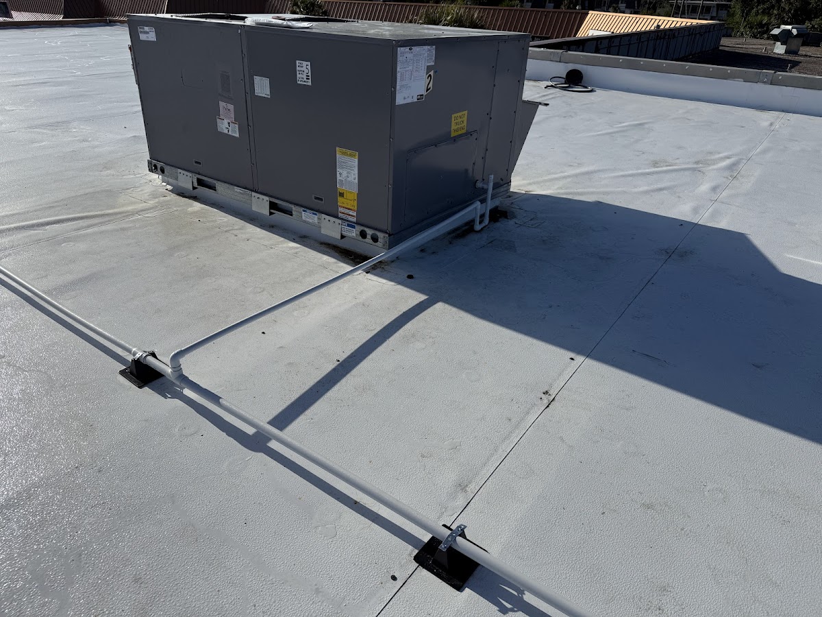 Rooftop HVAC unit professionally installed with secure connections for reliable commercial climate control.