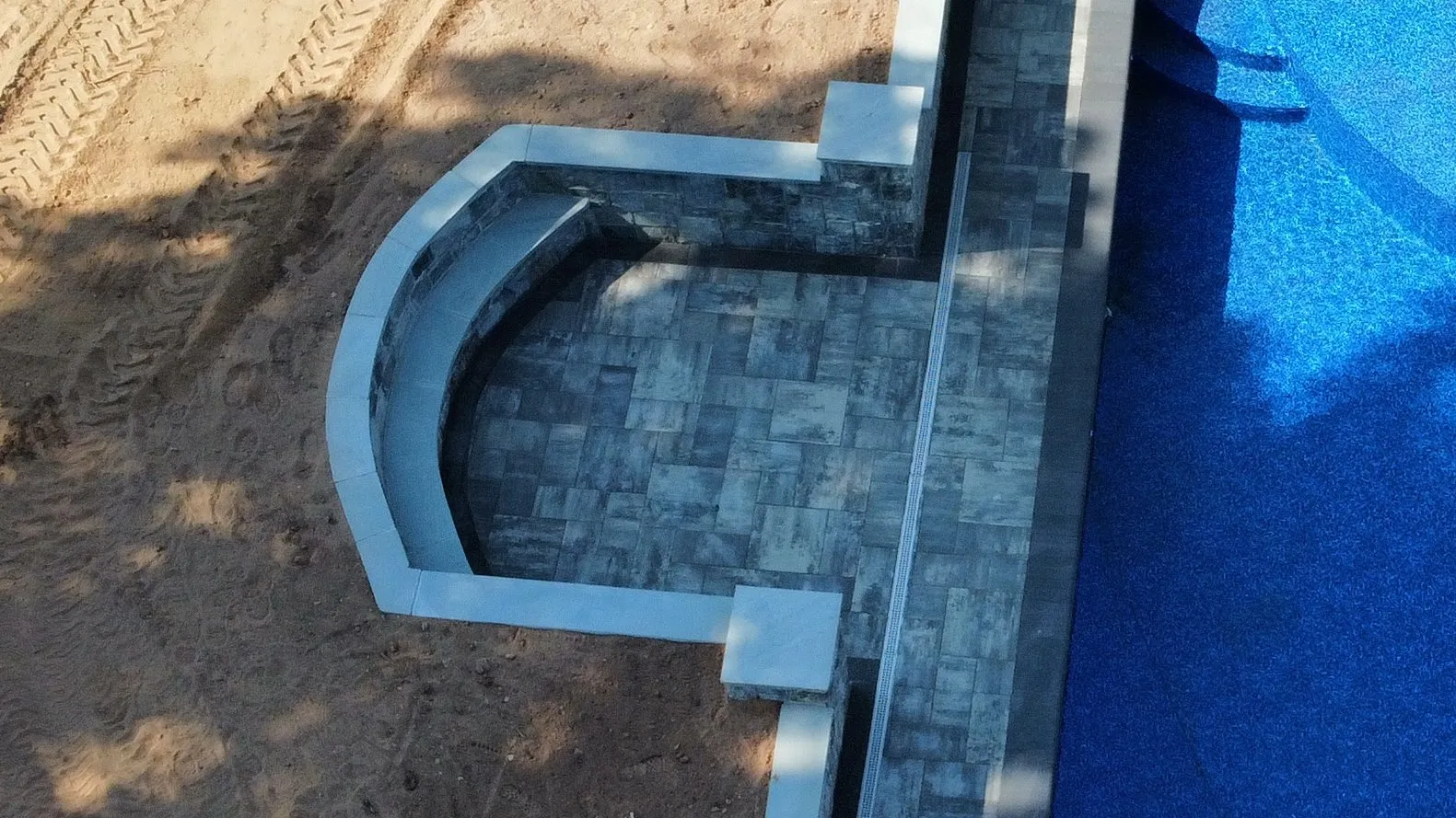 Stone seating wall built for outdoor entertaining - Stone Retaining Walls project by General Masonry LLC.