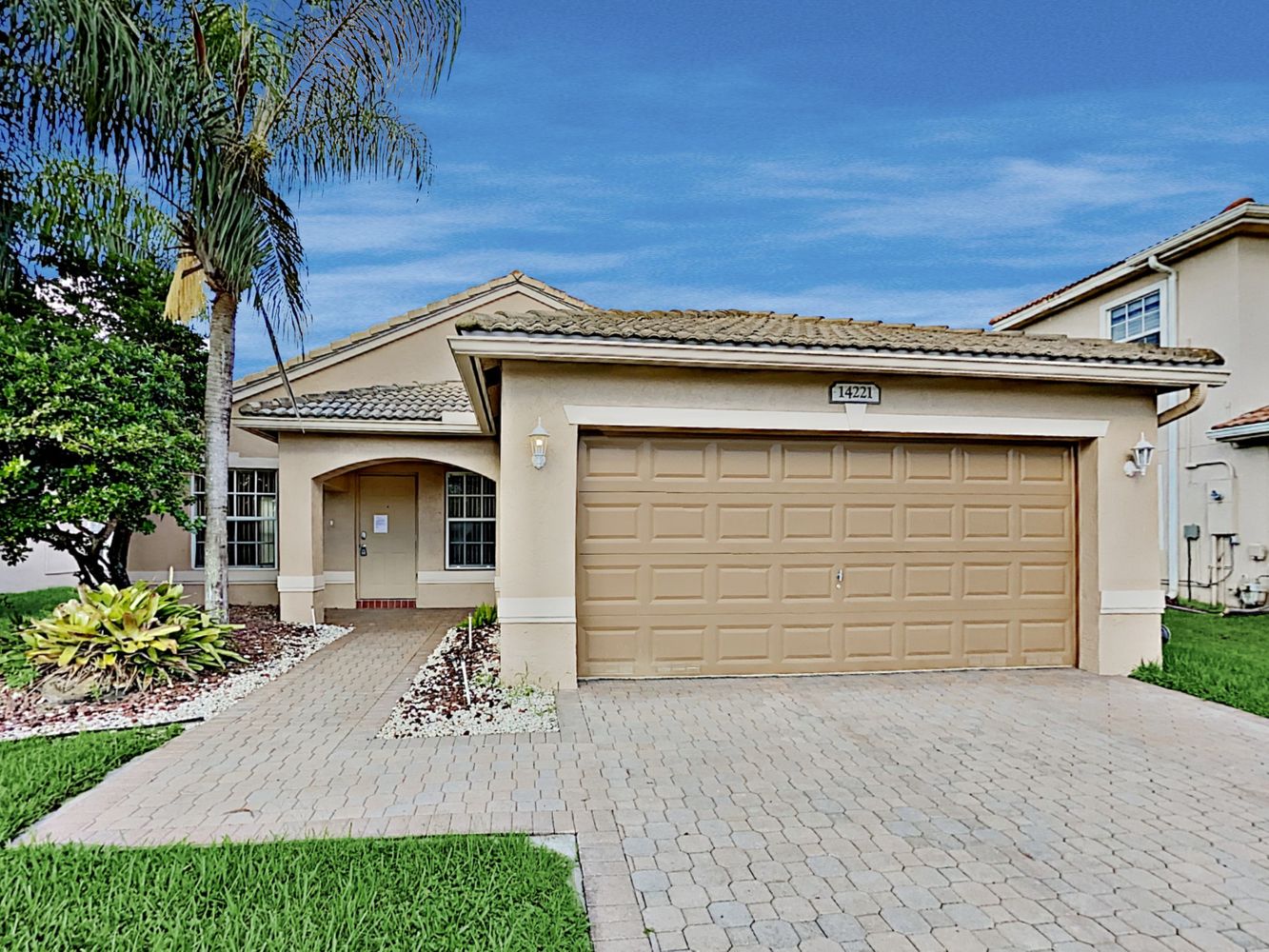 Charming home with two-car garage and covered porch at Invitation Homes South Florida.