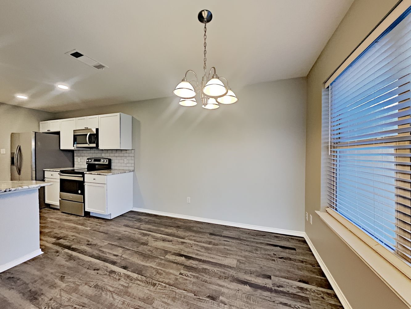 Cozy nook for dining table connected to kitchen at Invitation Homes Dallas.