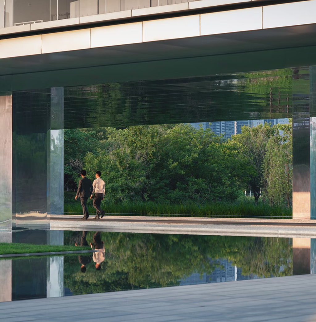 Two businessmen walking in an architectural park.