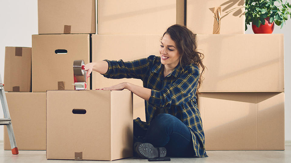 student packing boxes for storage