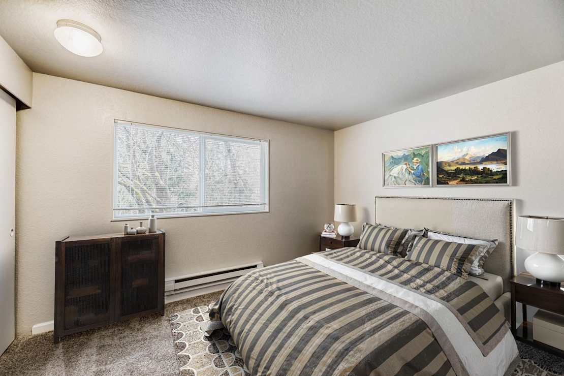 A bedroom with striped bedding