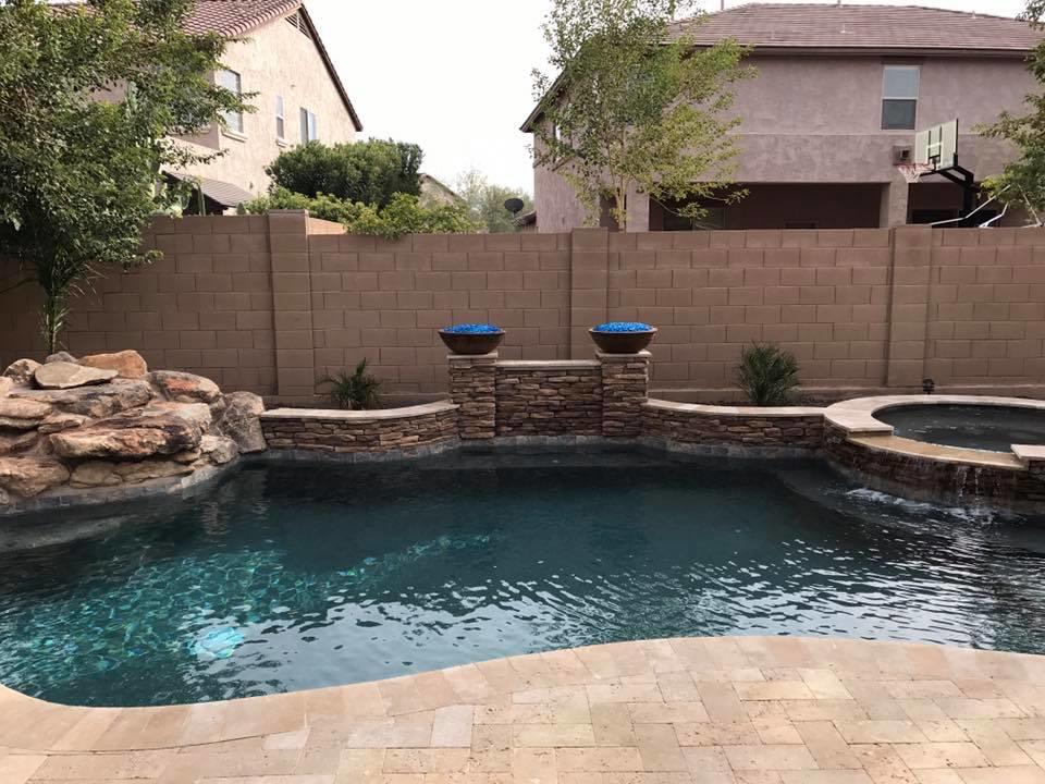 Rock ledge on one side of pool with fire bowls No Limit Pools & Spas Mesa (602)421-9379