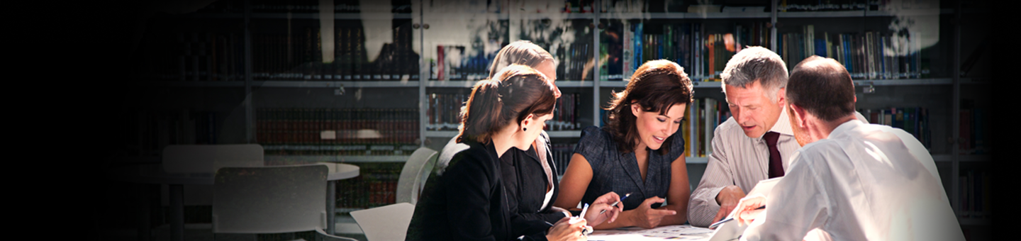Group of advisors collaborating closely around a table.