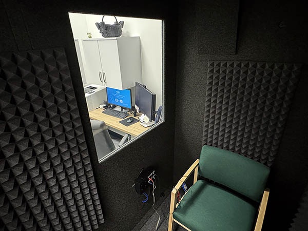 Interior photo of the sound proof hearing testing booth in the AudioNova hearing clinic in Batavia, IL