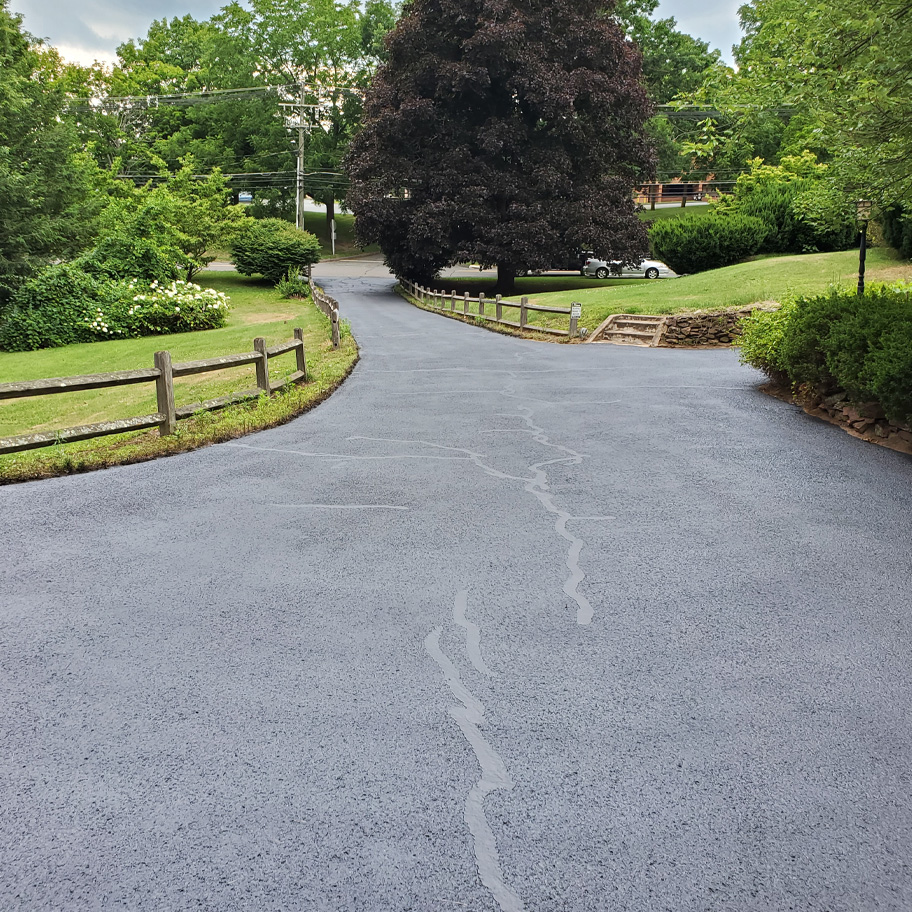 The client's asphalt was over 20 years old, turning grey and cracking.