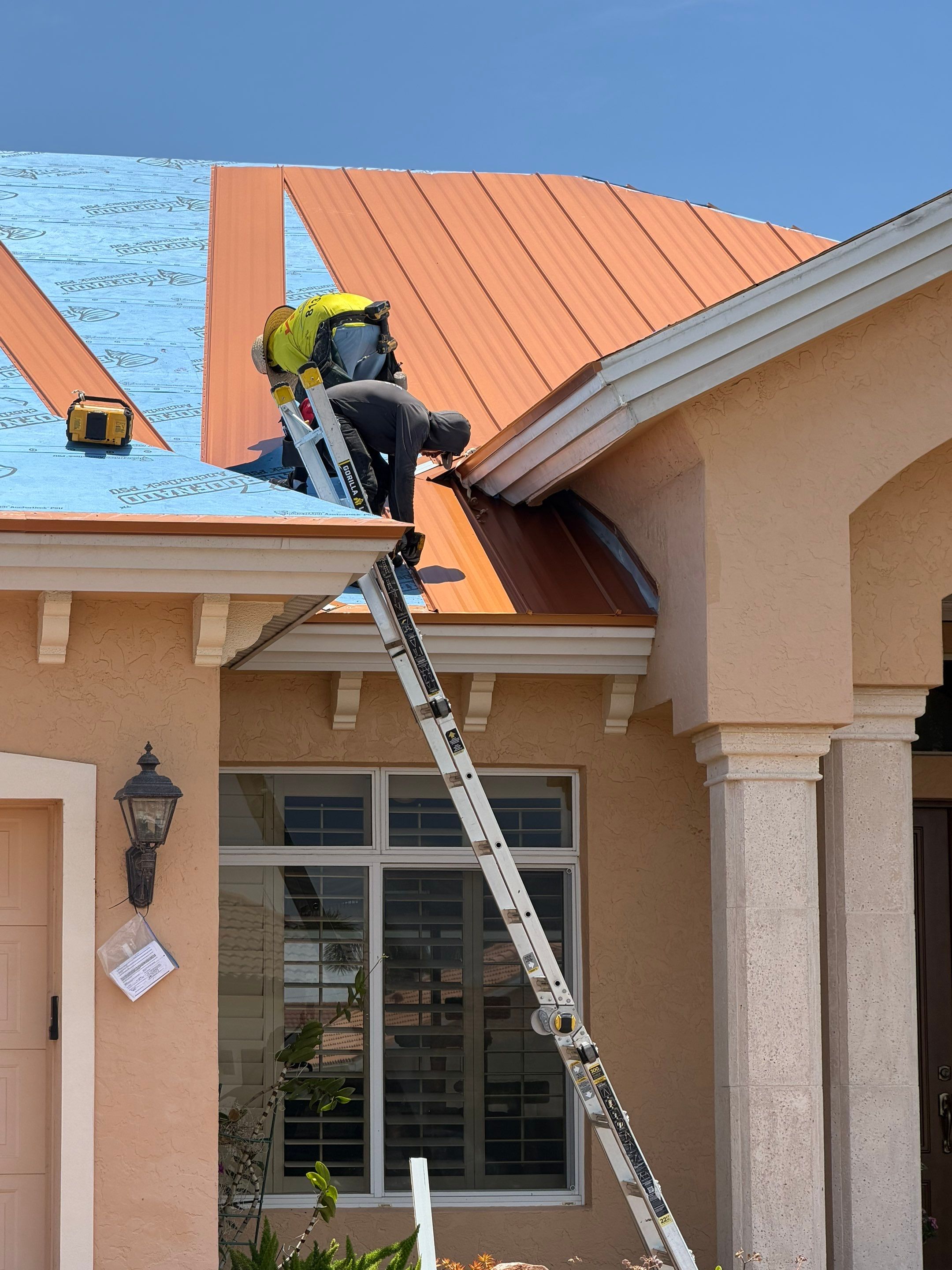 Solar-powered roof vent installed on a copper standing seam metal roof for improved attic ventilatio 