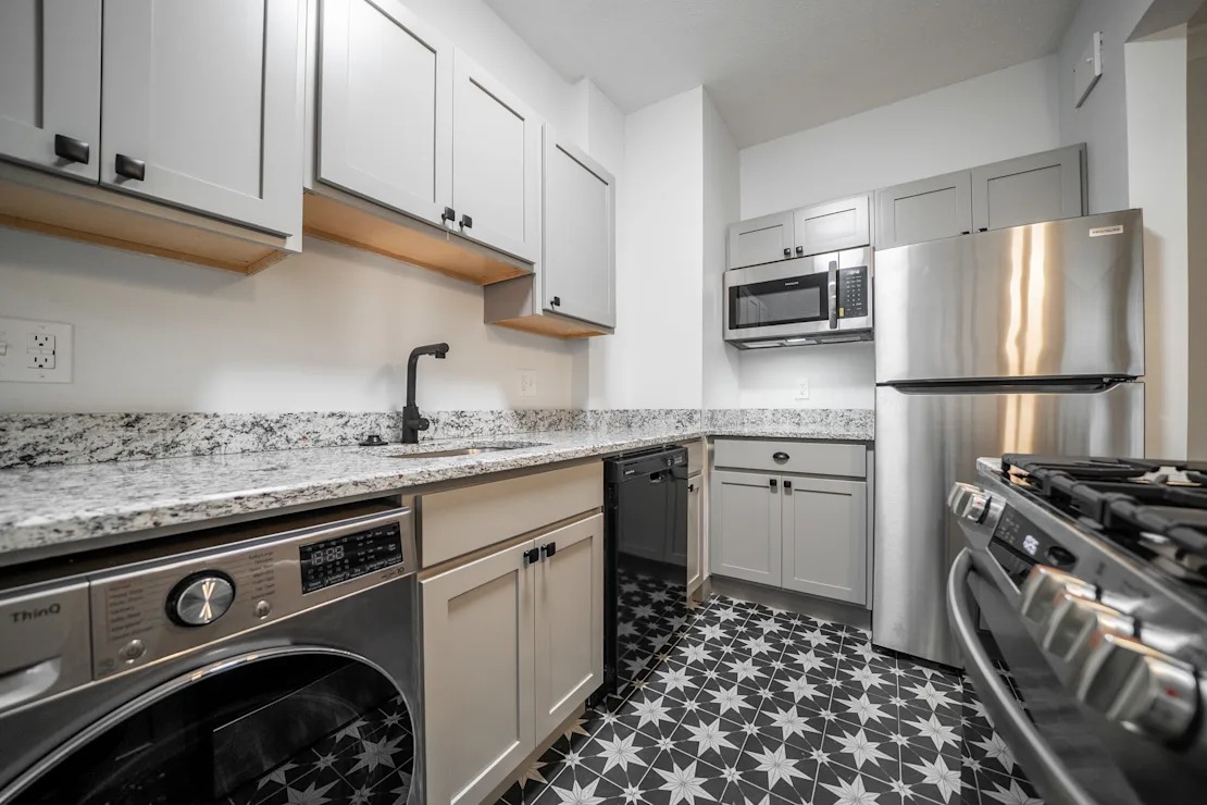 A kitchen with a black and white floor.