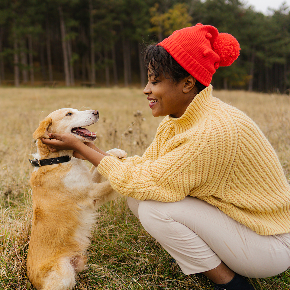 A woman and dog in a field